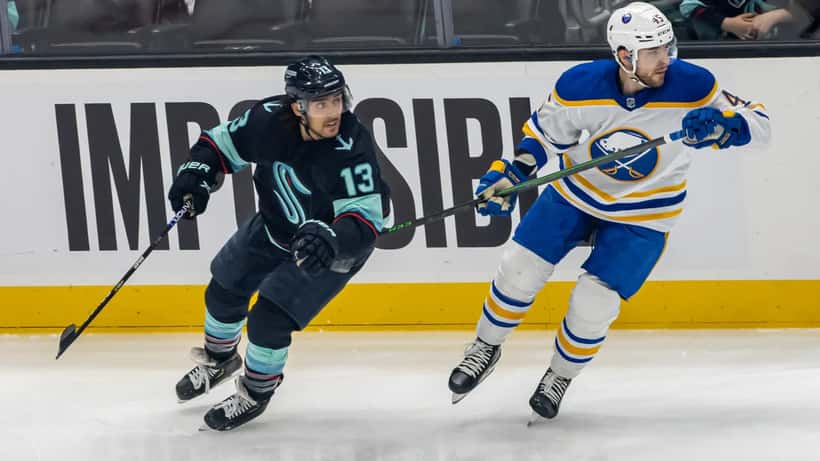 Buffalo Sabres players competing in NHL ice hockey game action