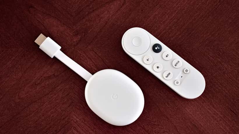 Chromecast with Google TV streaming device and remote on a wooden table