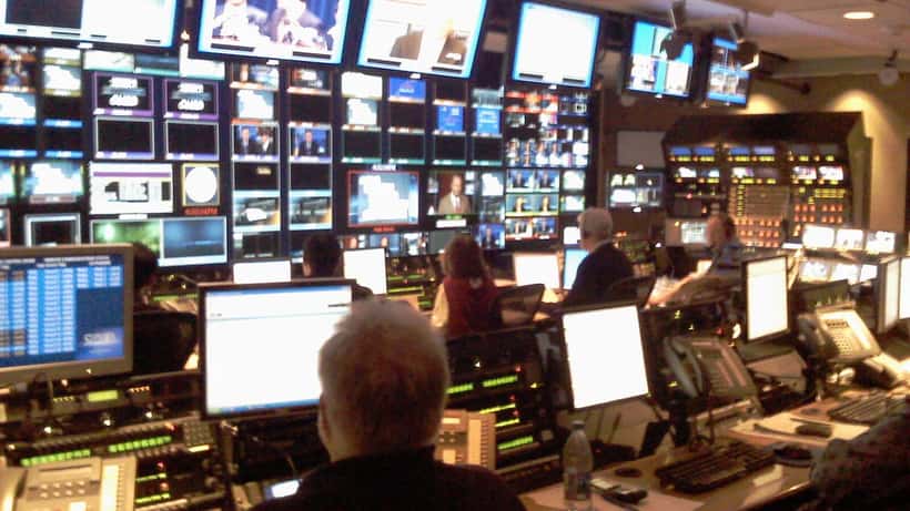 Toimittaja television uutislähetyksessä studiossa