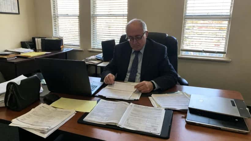 Immigration lawyer reviewing visa documents and Australian Home Affairs paperwork in a Sydney office