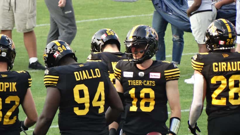 Hamilton Tiger-Cats players in a CFL game action shot at Molson Stadium