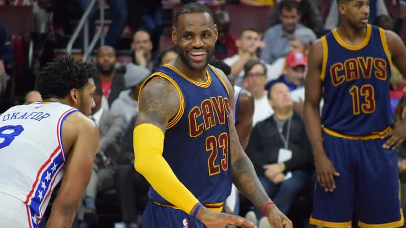 Sports medicine physician examining an athlete's hamstring injury in a clinical treatment room