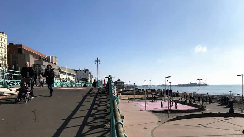 Brighton seafront and pier on a sunny summer day with beachgoers