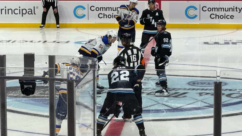 Utah Hockey Club players on ice during an NHL game, representing playoff intensity and athlete injury risk